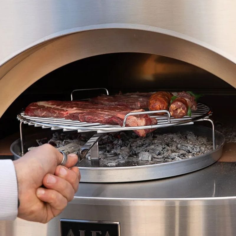 Chef grilling meat inside the Classico Gas Pizza Oven