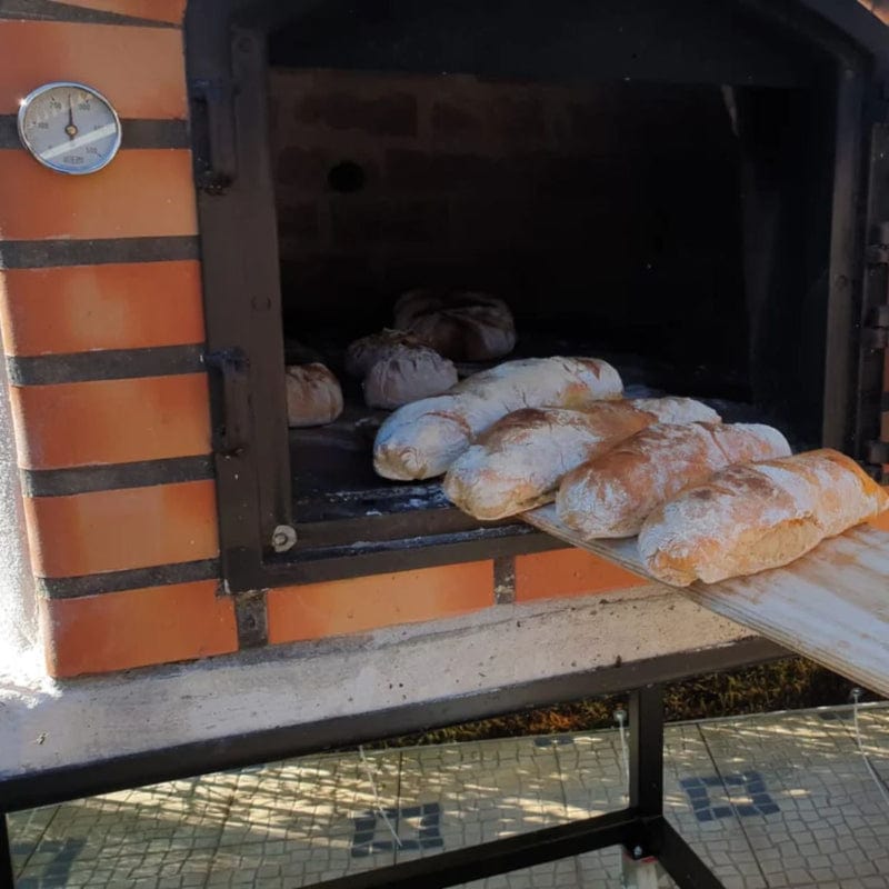 Baking bread inside the Lisboa Premium Brick Wood Fired Pizza Oven