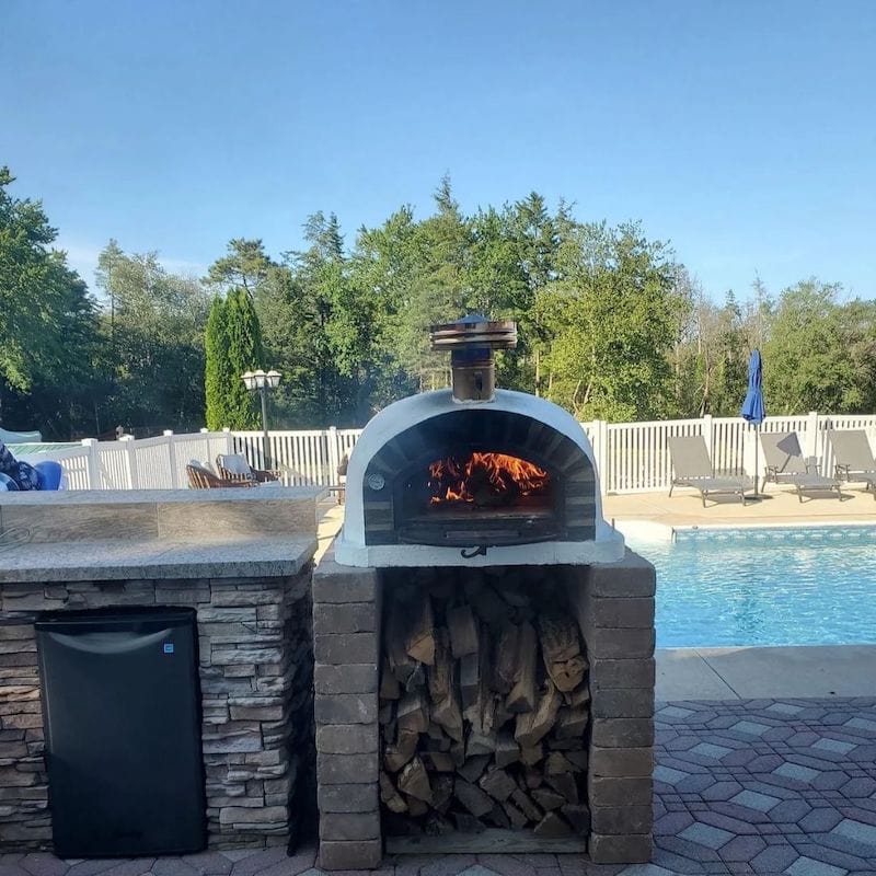 Pizzaioli Stone Arch Brick Oven next to the pool