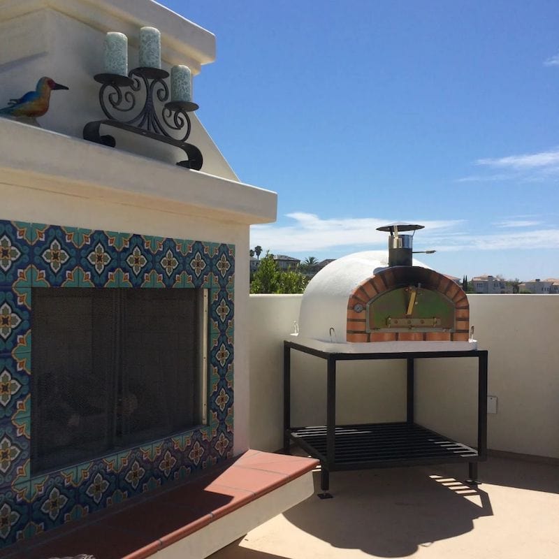 Pizzaioli Traditional BrickOven next to an outdoor fireplace