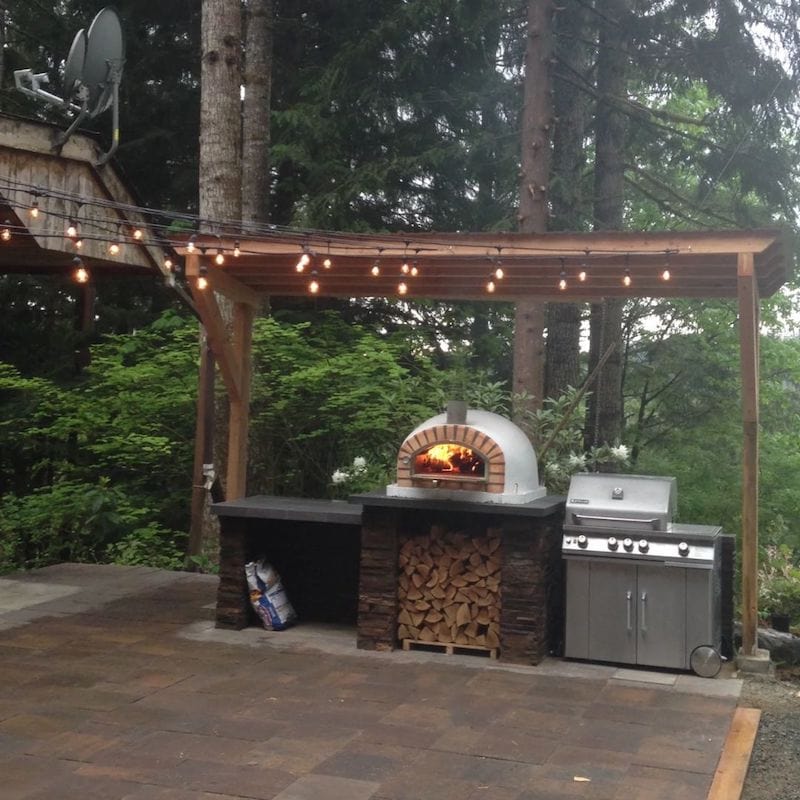 Traditional Pizzaioli Brick Oven next to a grill under a pergola