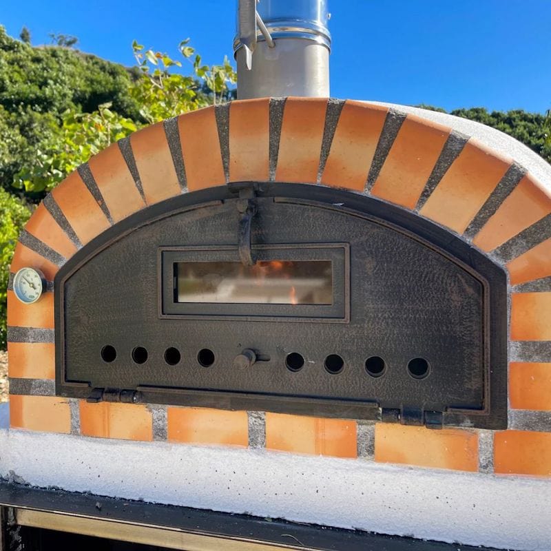 Close up details of the terracotta orange tones of the Premium Pizzaioli Brick Wood Fired Pizza Oven