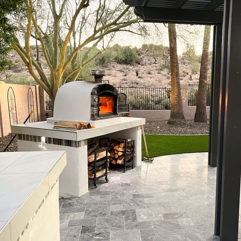 Ventura Preto Brick Pizza Oven displayed in an outdoor kitchen