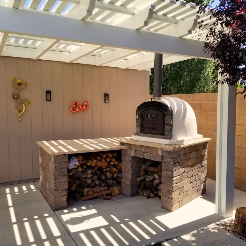 Ventura Preto Brick Wood Fired Pizza Oven under a Pergola